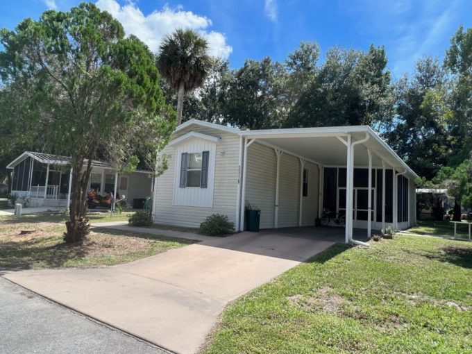 home with driveway and grassy lawn